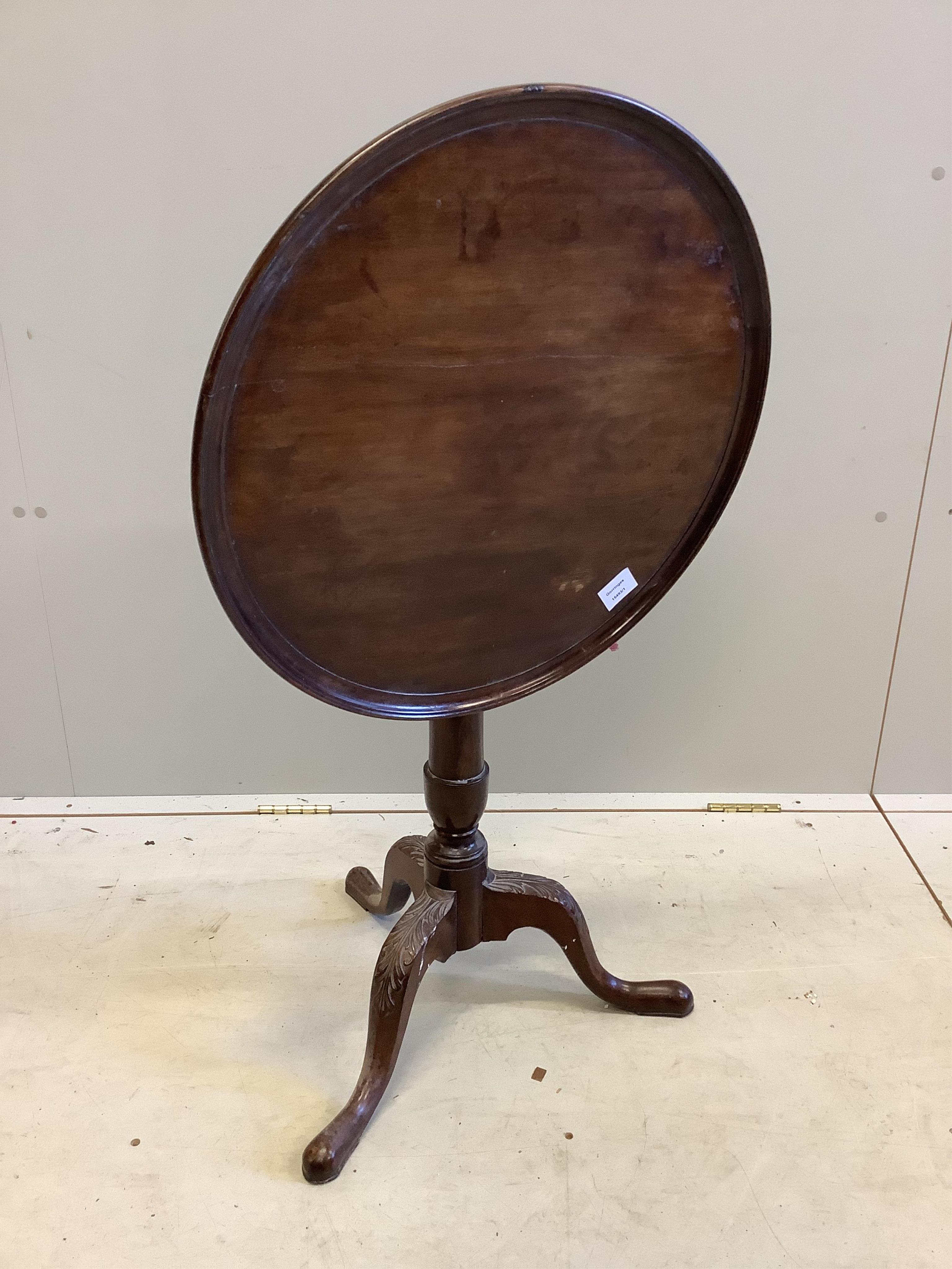 An Edwardian George III style circular mahogany tilt top wine table, on carved cabriole legs, diameter 56cm, height 65cm. Condition - fair